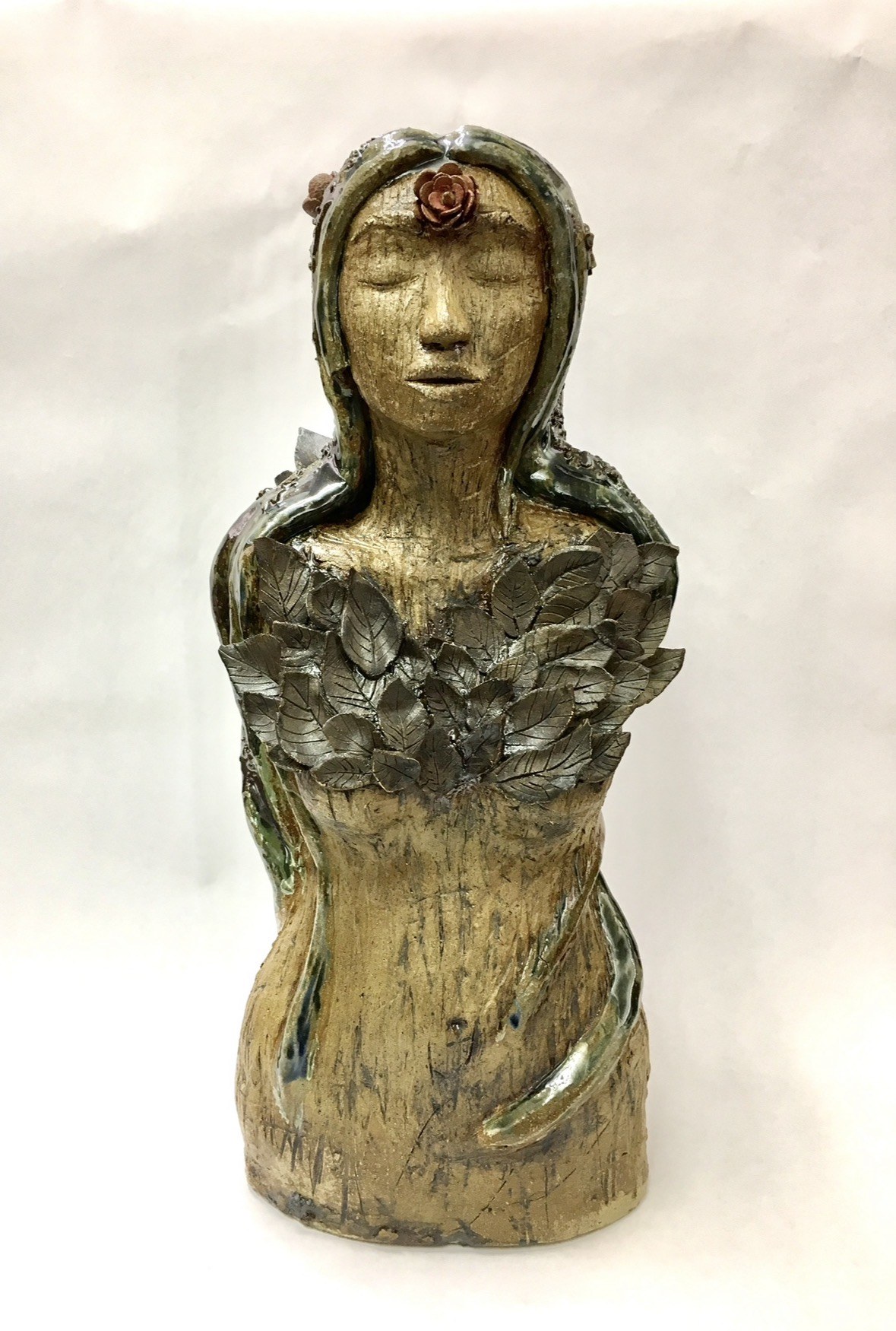 Ceramic sculpture of a woman with leaves, handmade by Faye