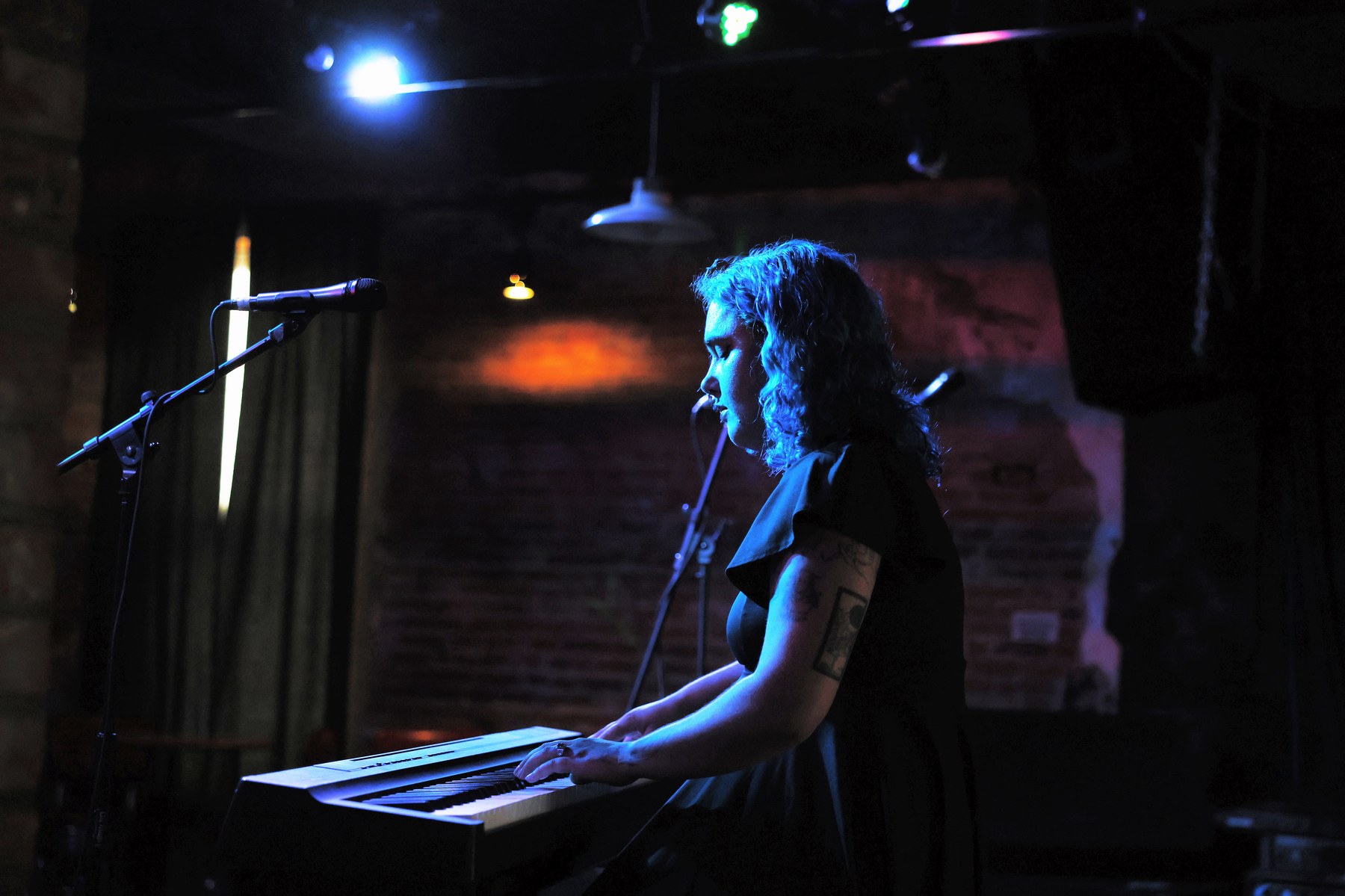 Faye performing a live piano set at a Quad Cities venue