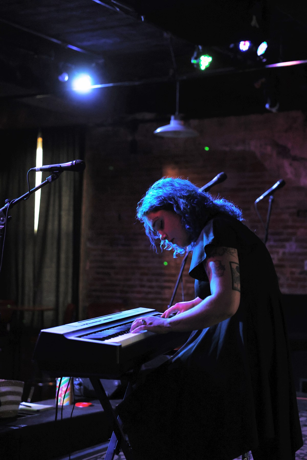 Faye playing piano during a live performance in the Quad Cities